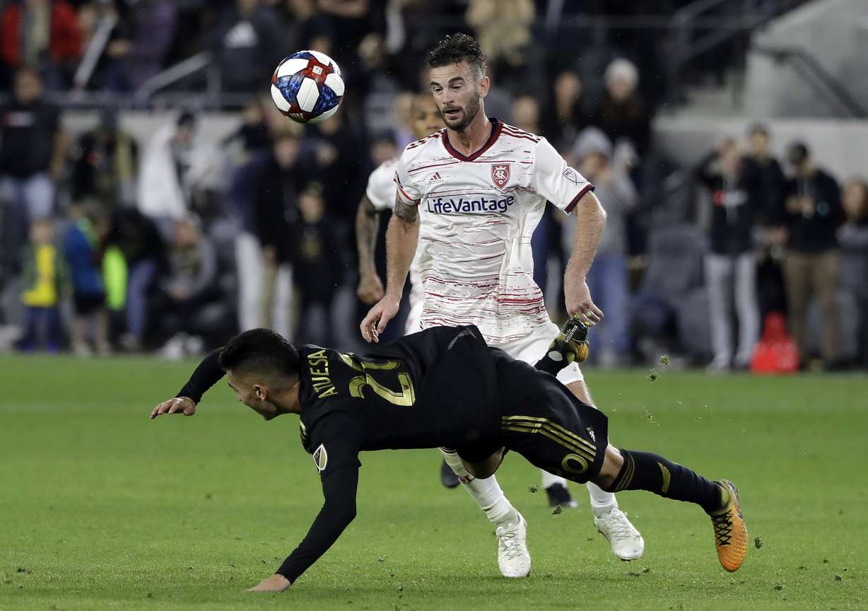 Los Angeles FC's Eduard Atuesta, bottom, falls in front of Real Salt Lake's Kyle Beckerman during the second half of an MLS soccer match Saturday, March 23, 2019, in Los Angeles. (Photo: Marcio Jose Sanchez, AP)