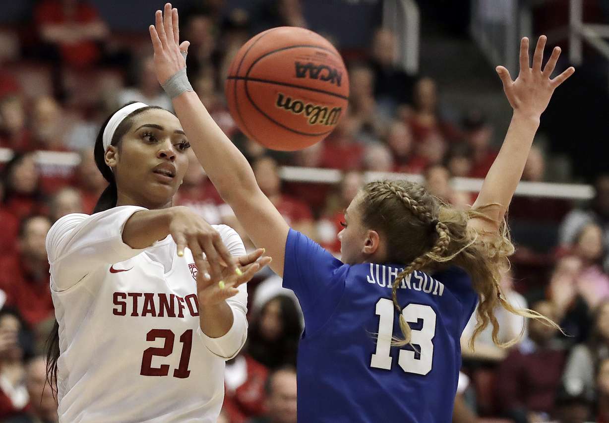 Stanford's DiJonai Carrington, left, passes away from BYU guard Paisley Johnson (13) in the second half of a second-round game in the NCAA women's college basketball tournament Monday, March 25, 2019, in Stanford, Calif. Johnson is among the three-proned guard line that returns for BYU next season. (Photo: Ben Margot, AP)