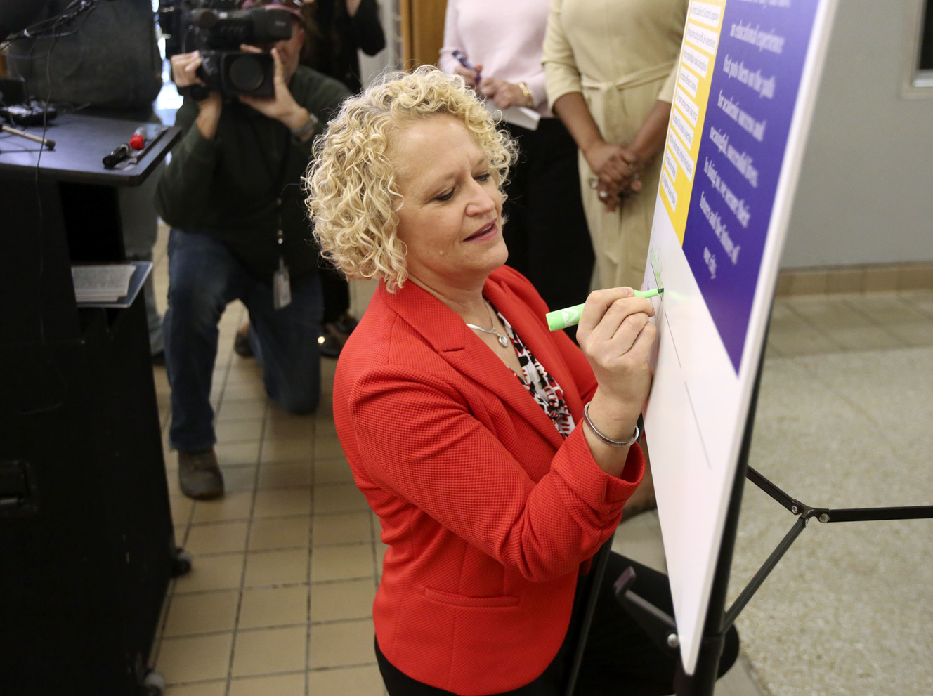 Salt Lake City Mayor Jackie Biskuspki signs a new agreement between the city, police and the Salt Lake City School District that aims to improve the role of school resource officers on campuses during a press conference at West High School in Salt Lake City on Tuesday, March 26, 2019. Photo: Kristin Murphy, KSL