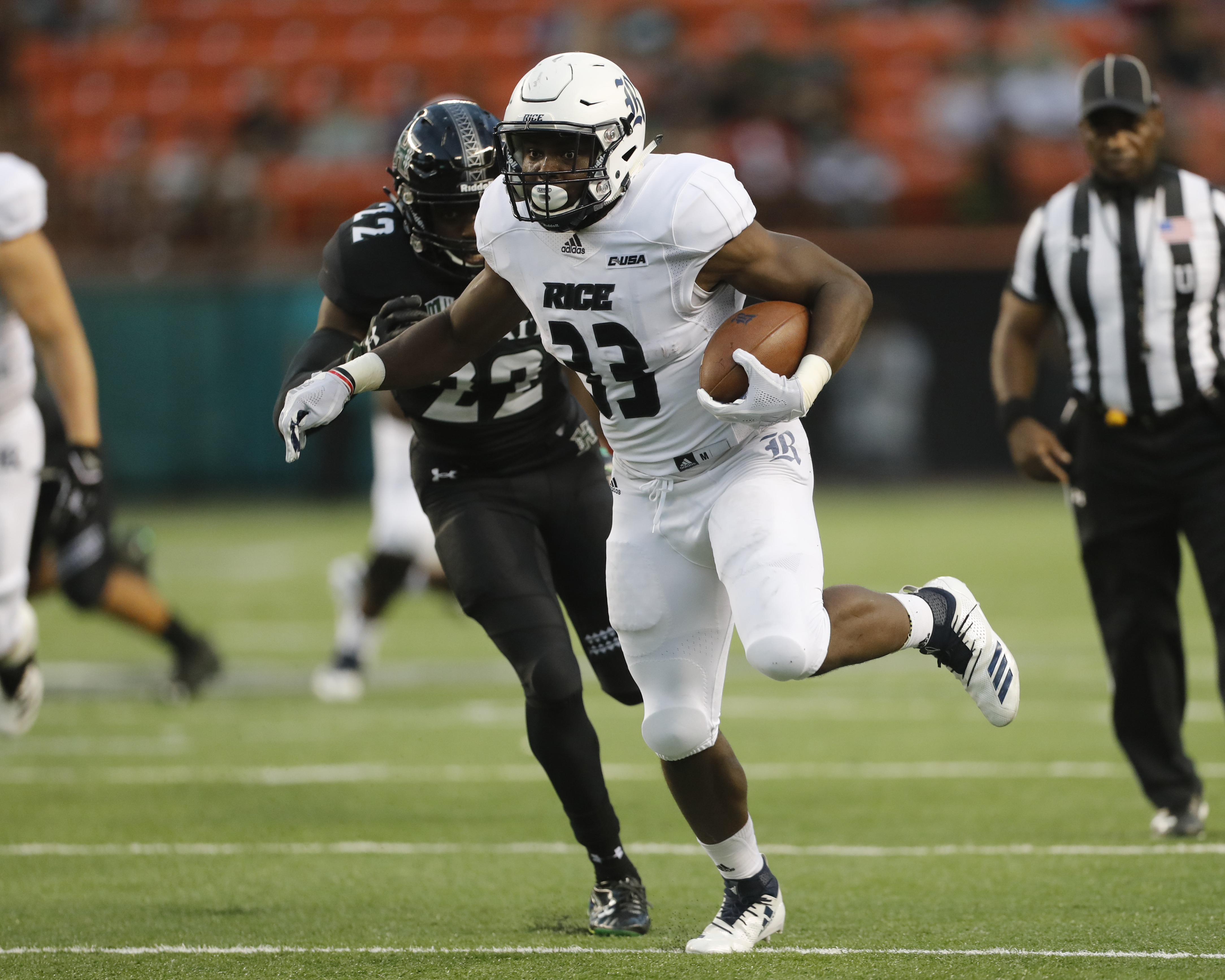 Rice running back Emmanuel Esukpa (33) runs away from Hawaii defensive back Ikem Okeke (22) for a touchdown during the first quarter of an NCAA college football game Saturday, Sept. 8, 2018, in Honolulu. (Photo: Marco Garcia, AP)