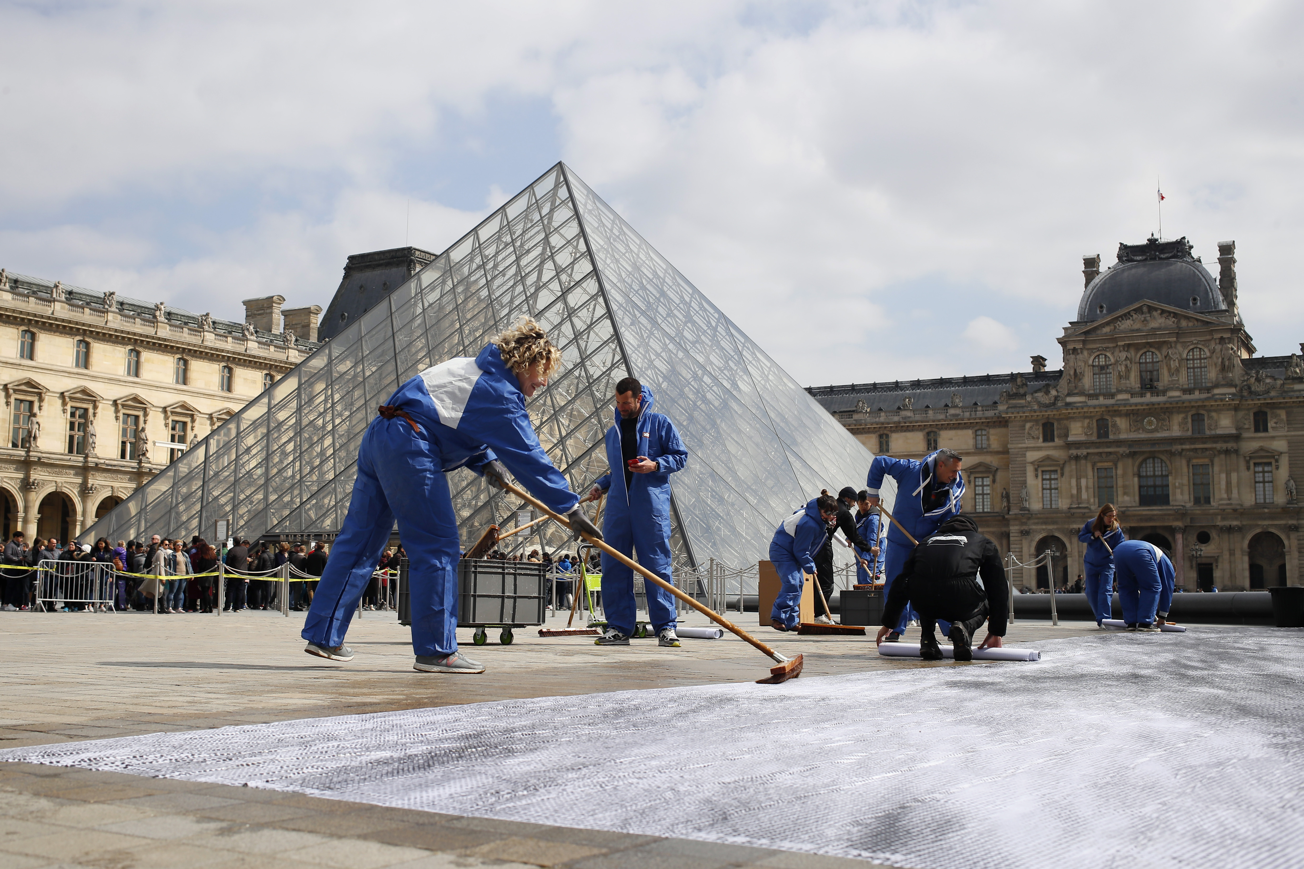 Amid gripes, Louvre pyramid celebrates 30 years with collage
