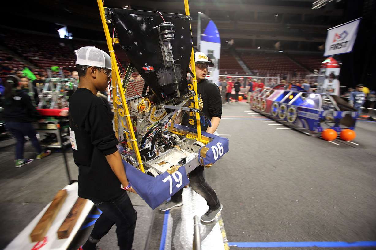 Aye Chan and Abdul Ayubi carry the robot into the arena as they and other students from Cottonwood High School compete in the First Robotics Competition Utah Regional event at the Maverik Center in West Valley City, Utah, on Friday, March 29, 2019. (Photo: Scott G Winterton, KSL)