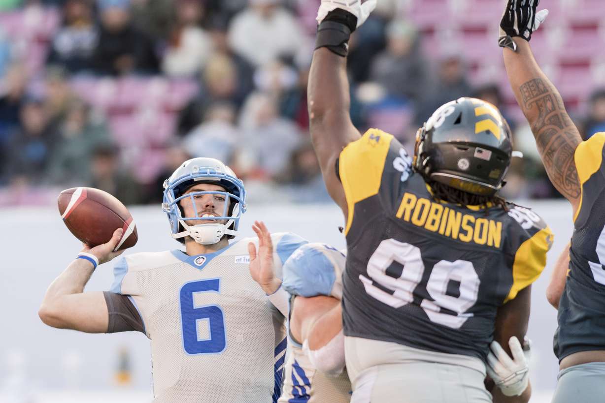 Salt Lake Stallions quarterback Josh Woodrum (6) makes a pass over the outstretched arms of San Diego Fleet defensive tackle Andrew Stelter (99) in the first half during an Alliance of American Footaball game, Saturday March 30, 2019 in Salt Lake City. (Photo: Tyler Tate, AP)