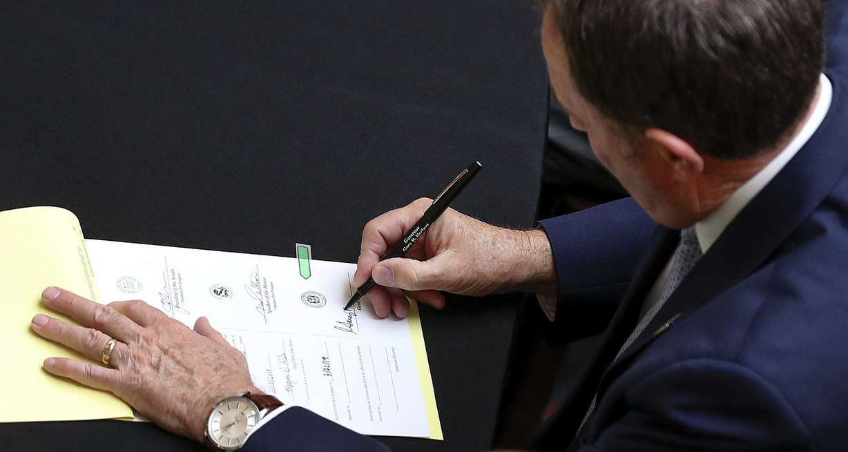 Gov. Gary Herbert signs the hate crime bill SB103 into law during a ceremony in the Capitol rotunda in Salt Lake City on Tuesday, April 2, 2019. (Photo: Steve Griffin, KSL)