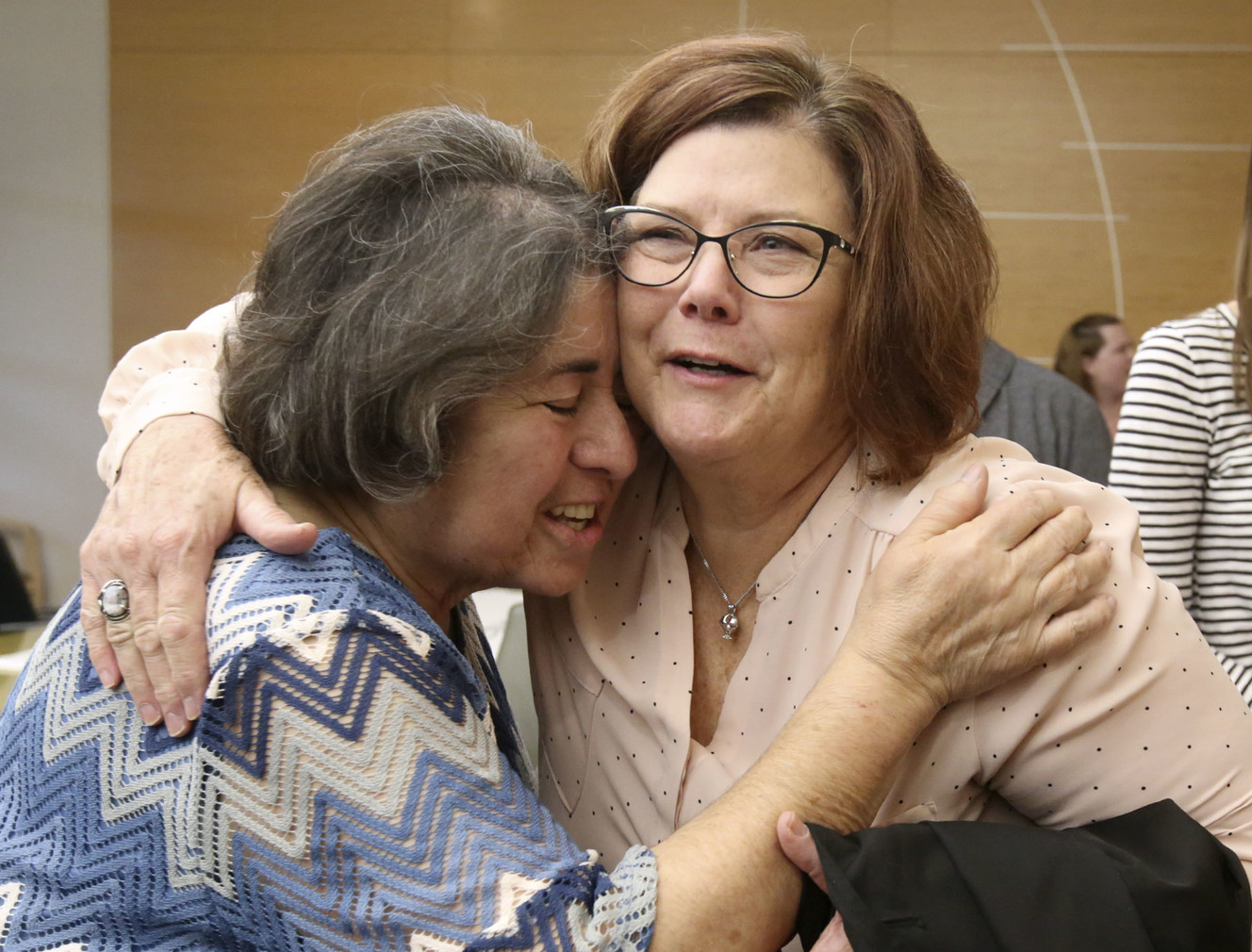 Evelyn Morgas, whose daughter was an organ donor, gets a hug from Alana Fivas, Intermountain Donor Services family services administration assistant, before a ceremonial flag raising to kick off National Donate Life Month at the University of Utah Hospital in Salt Lake City on Tuesday, April 2, 2019. (Photo: Kristin Murphy, KSL)