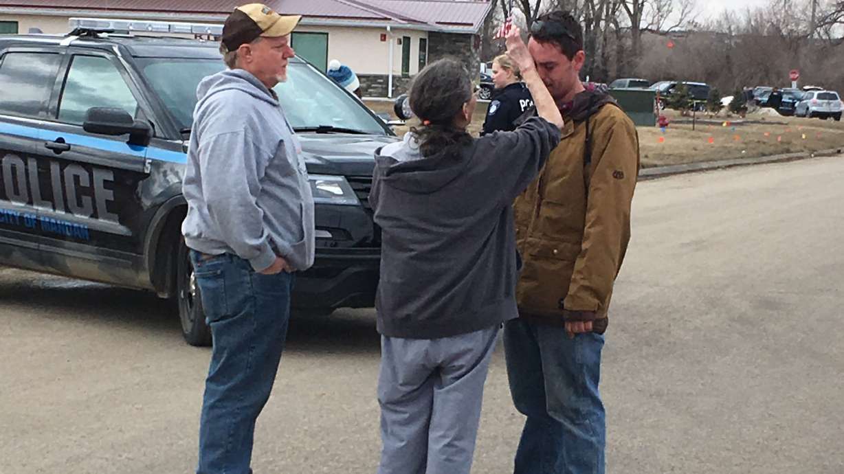 The Latest: Field searched near company where 4 found slain