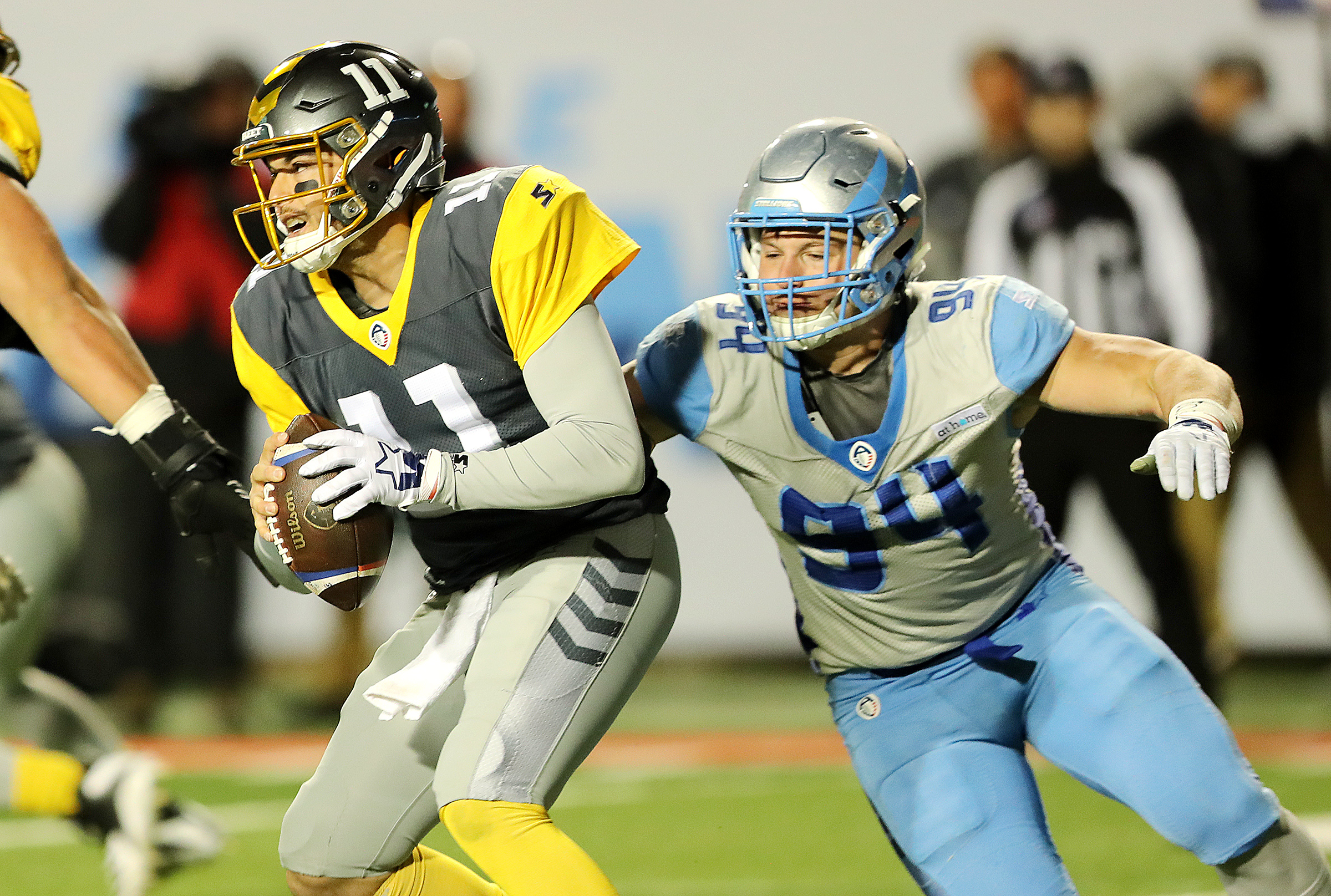 San Diego Fleet quarterback Mike Bercovici (11) escapes Salt Lake Stallions defensive end Karter Schult (94) as the Salt Lake Stallions play the San Diego Fleet in an Alliance of American Football game at Rice Eccles Stadium in Salt Lake City on Saturday, March 30, 2019. The Stallions, along with the rest of the AAF, folded after just five weeks.