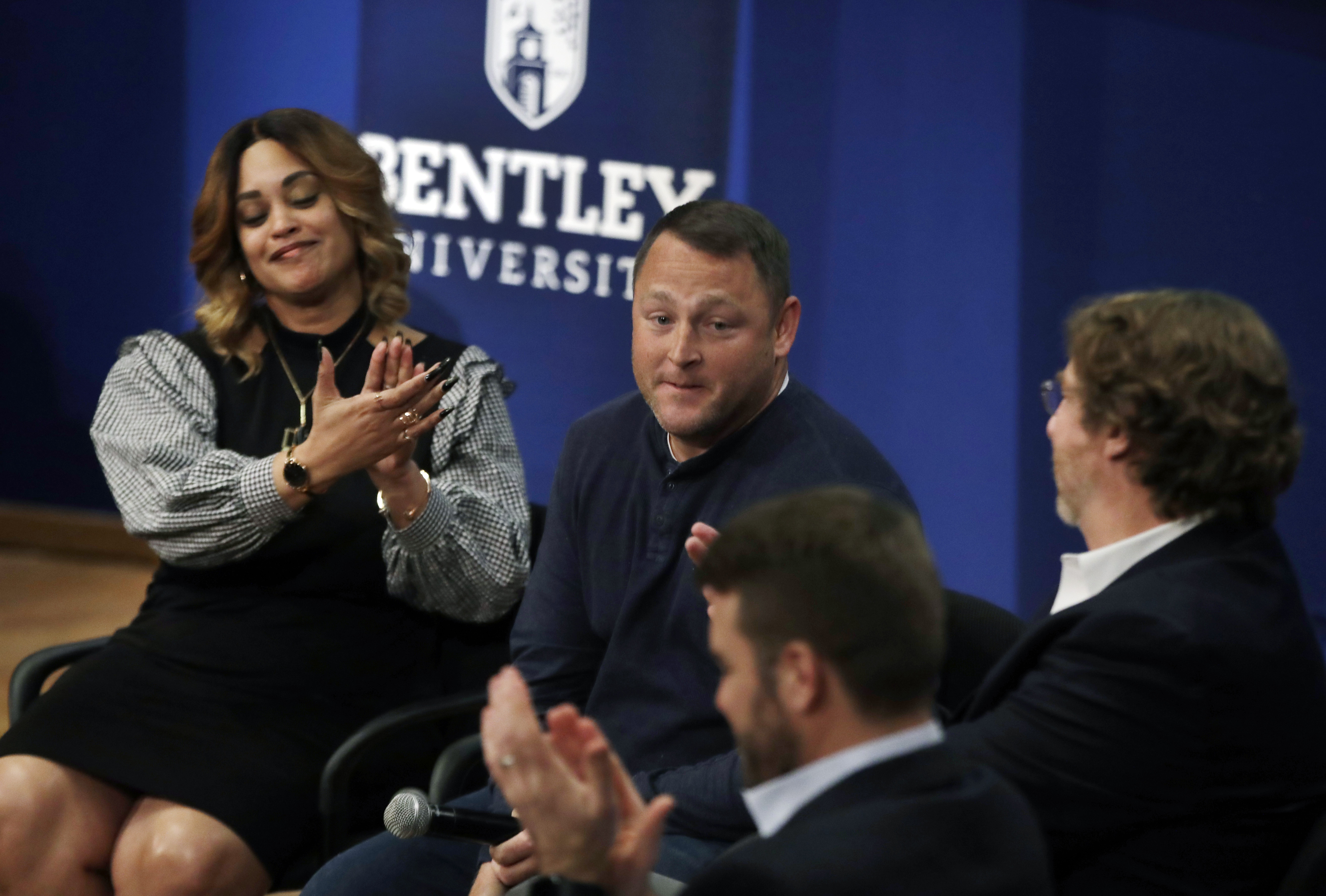 In this March 5, 2019 photo, panel members including Natalie Baucum, left, applaud Mike Duggan, middle, during an event at Bentley University, in Waltham, Mass., where professors and alumni shared some of their worst setbacks. Photo: Elise Amendola, AP Photo