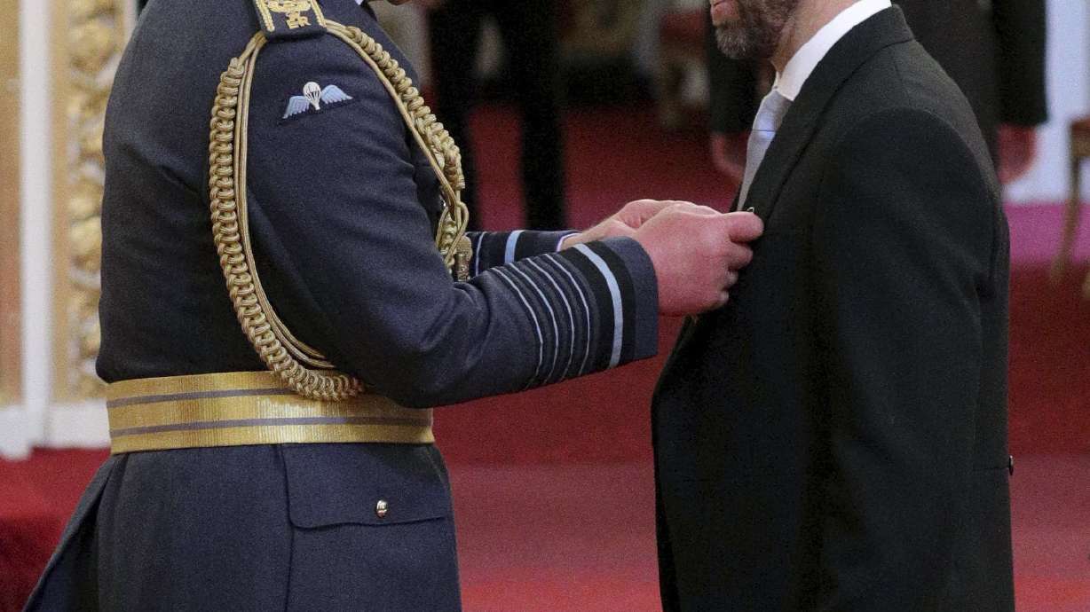 Back in his vest, Southgate gets honor at Buckingham Palace