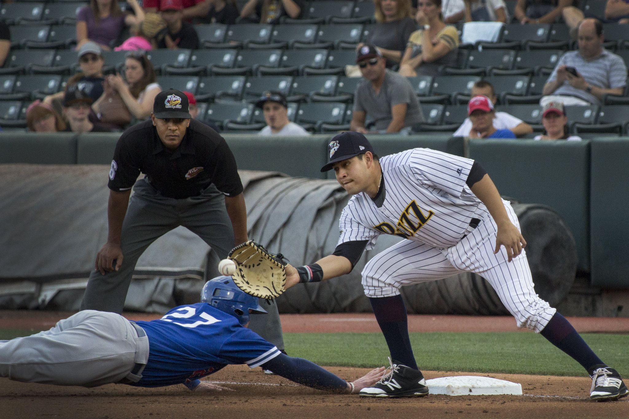 Oklahoma City Dodgers outfielder Alex Verdugo beats a tag by Salt Lake Bees first baseman Ramon Flores during a game in Salt Lake City on Aug. 10, 2017. The Bees were wearing a throwback jersey honoring the Buzz that day. (Photo: Carter Williams, KSL.com, File)