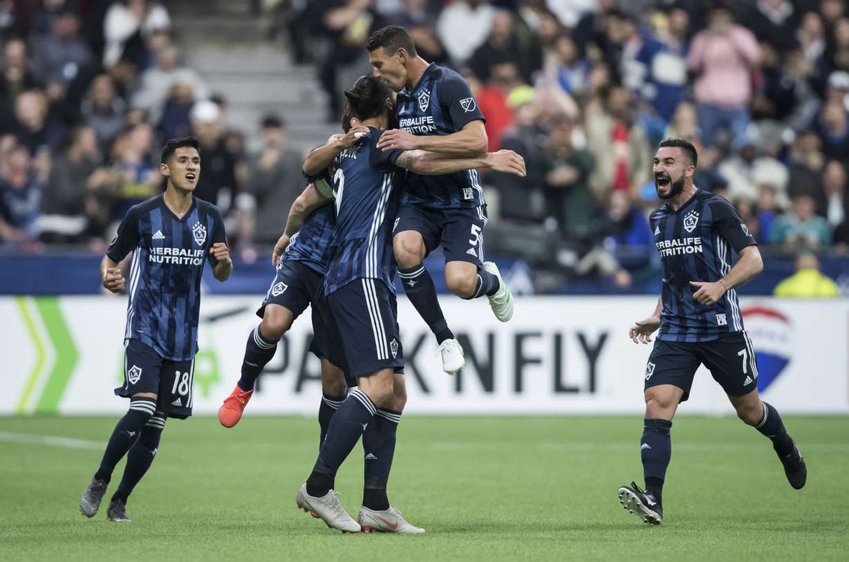 LA Galaxy's Uriel Antuna, Jonathan dos Santos, back, Zlatan Ibrahimovic, Daniel Steres and Romain Alessandrini, from left, celebrate Ibrahimovic's goal against the Vancouver Whitecaps during the second half of an MLS soccer match April 5, 2019. (Photo: Darryl Dyck, The Canadian Press via AP)