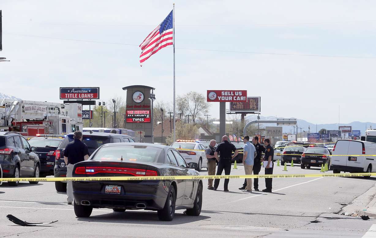 Police officers investigate after a robbery suspect is shot dead after a high speed chase that ended in a hail of gun fire near 3300 South State Street in Salt Lake City on Monday, April 8, 2019. Multiple agencies responded to the incident. (Photo: Scott G. Winterton, KSL, File)