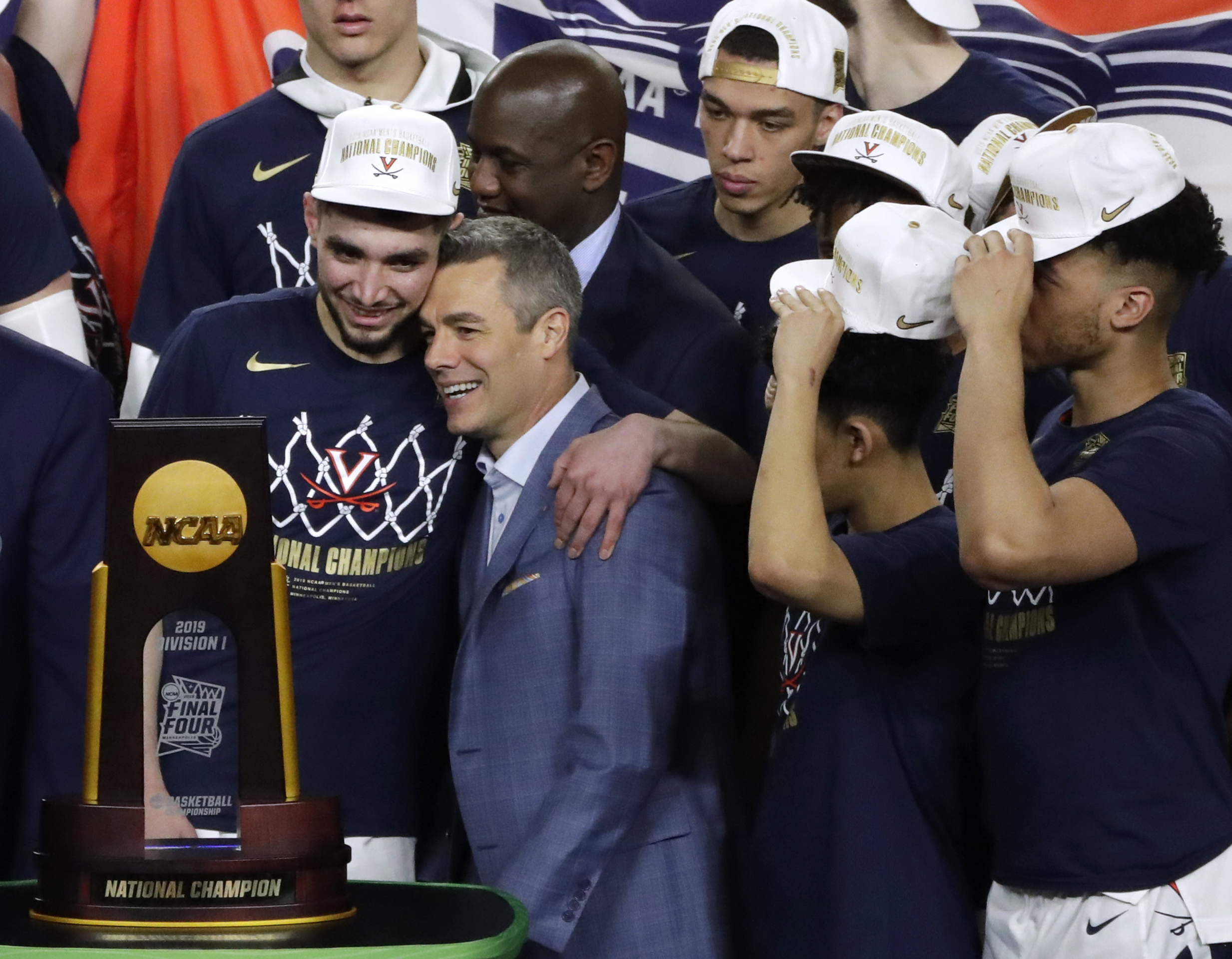 Virginia head coach Tony Bennett, center, celebrates with guard Ty Jerome, left, after the championship game against Texas Tech in the Final Four NCAA college basketball tournament, Monday, April 8, 2019, in Minneapolis. Virginia won 85-77 in overtime. (Photo: Matt York, AP)