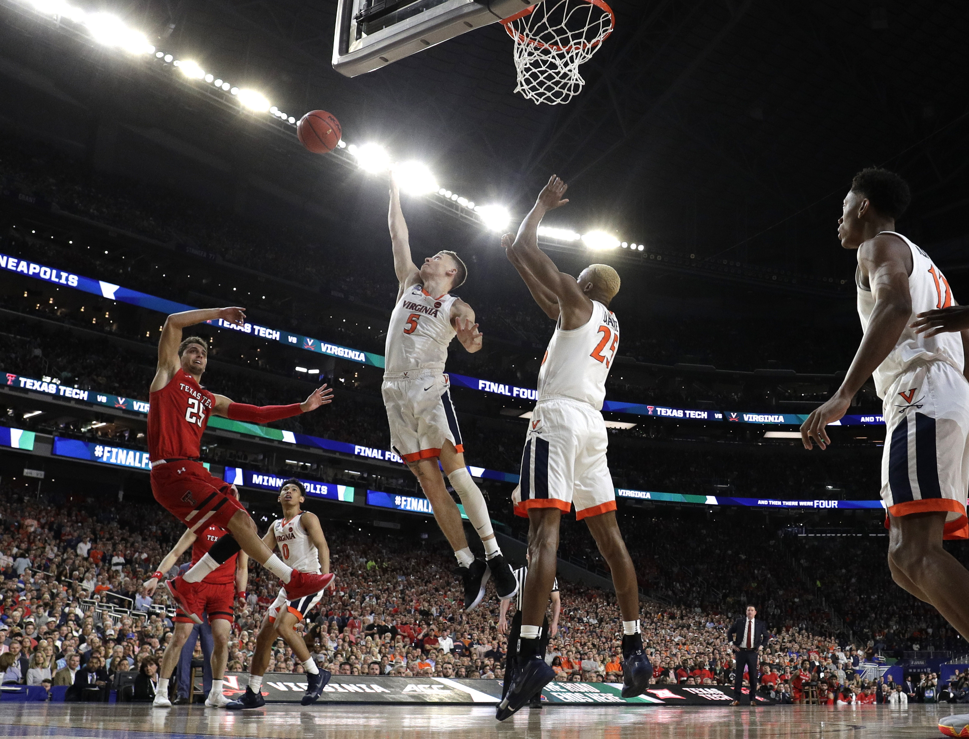 Texas Tech guard Davide Moretti left, shoots over Virginia's Kyle Guy (5) and Mamadi Diakite during the first half in the championship game of the Final Four NCAA college basketball tournament, Monday, April 8, 2019, in Minneapolis. (Photo: David J. Phillip, AP)