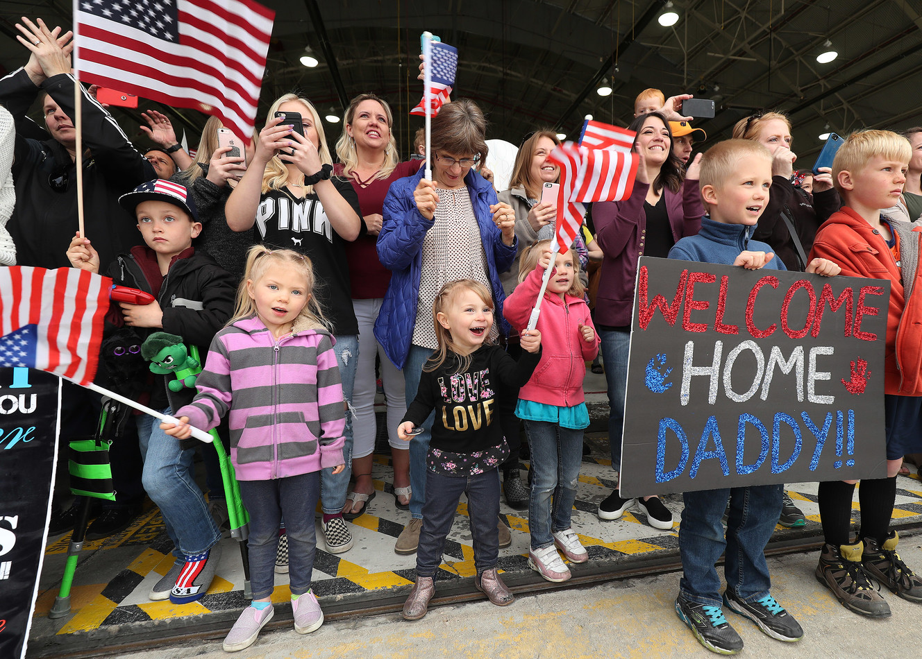 Family and friends cheer as the Utah Army National Guard’s Echo Battery, 1st Battalion, 145th Field Artillery, “Big Red,” arrives at Roland R. Wright Air Base in Salt Lake City on Tuesday, April 9, 2019, after being deployed to the Middle East. (Photo: Jeffrey D. Allred, KSL)