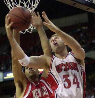 Chris Burgess (34) drives against New Mexico's Patrick Dennehy in 2001. (Photo: Deseret News Archive)