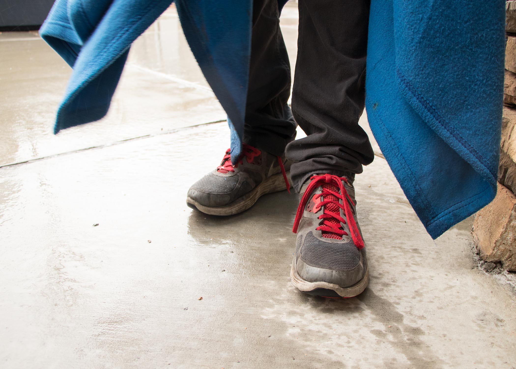 Austin's shoes poke out of his blanket as he wraps it around himself again. (Photo: Liesl Nielsen, KSL.com)