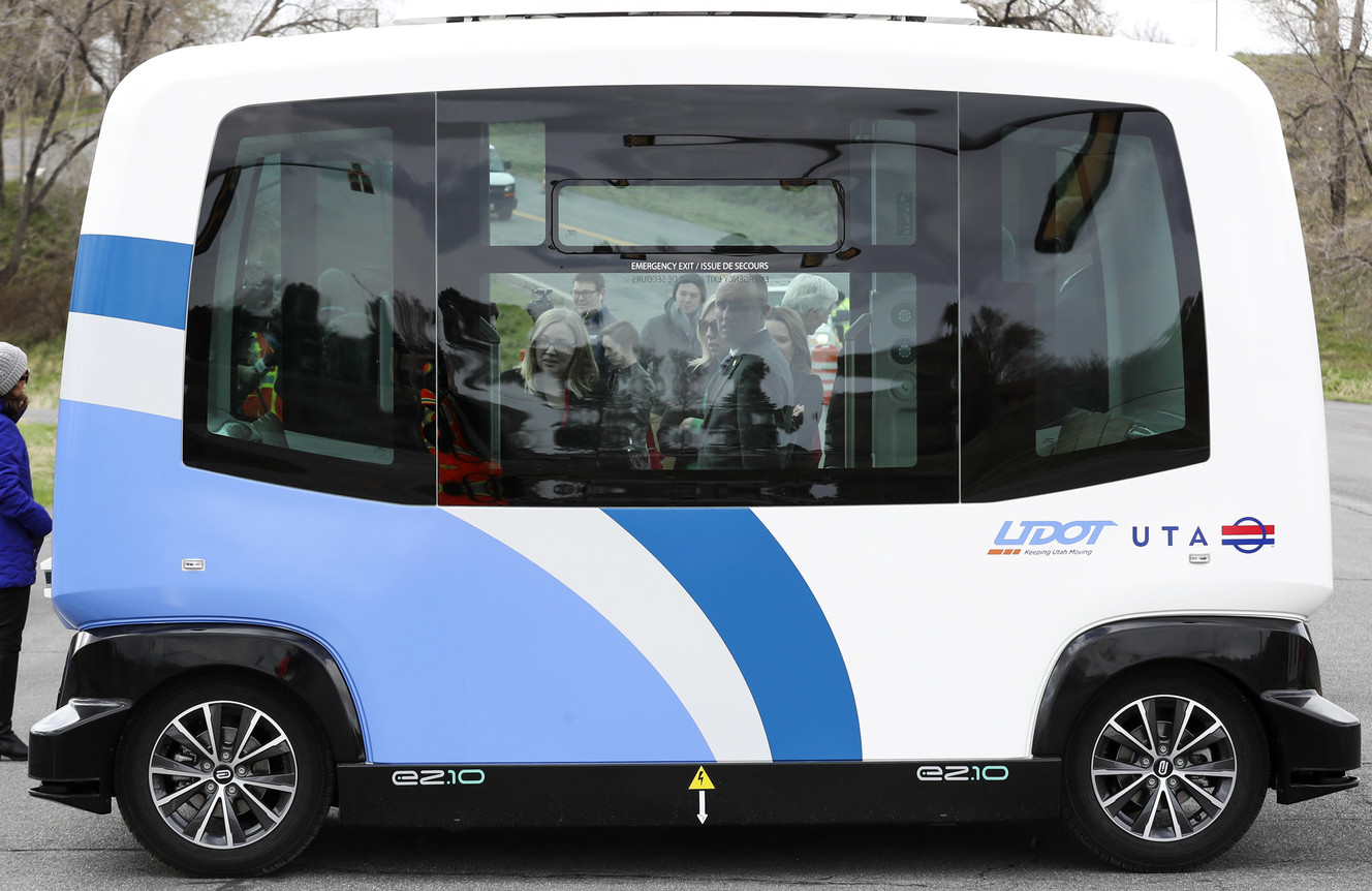 Lt. Gov. Spencer J. Cox, center, peers into an autonomous shuttle at the Utah Department of Transportation's test track in West Valley City on Thursday, April 11, 2019. The two agencies are testing driverless transportation technology to identify opportunities to improve safety, access and mobility to meet the needs of Utah communities. (Photo: Steve Griffin, KSL)
