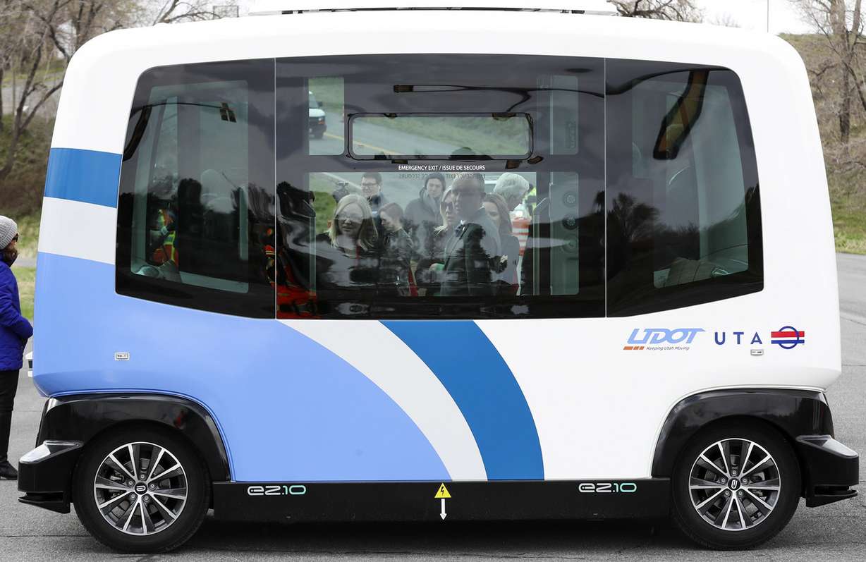 Lt. Gov. Spencer J. Cox, center, peers into an autonomous shuttle at the Utah Department of Transportation's test track in West Valley City on Thursday, April 11, 2019. The two agencies are testing driverless transportation technology to identify opportunities to improve safety, access and mobility to meet the needs of Utah communities. (Photo: Steve Griffin, KSL)
