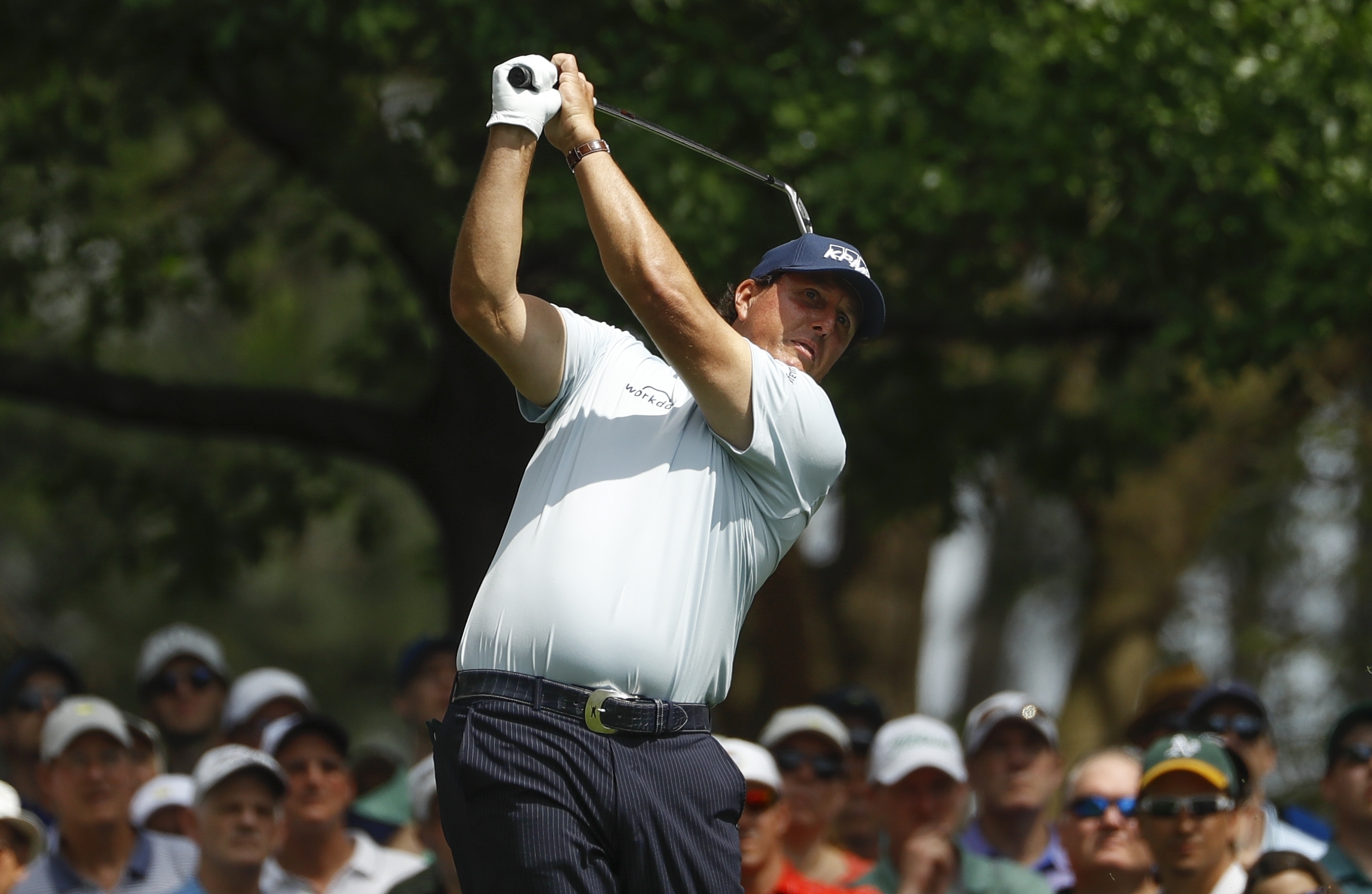 The Latest: Crowded leaderboard at Masters, Woods in the mix
