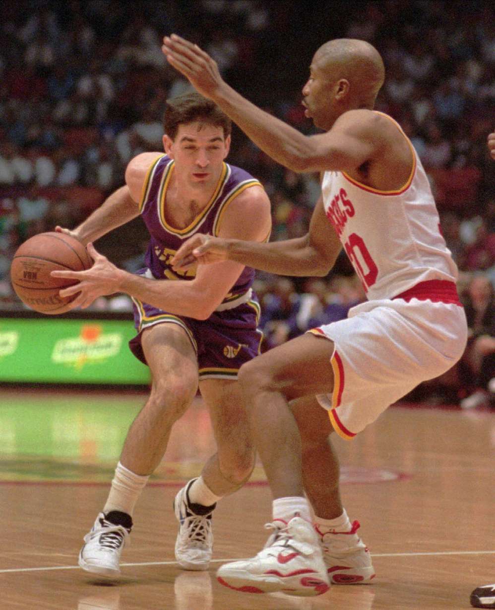 Utah Jazz's John Stockton, left, drives past Houston Rockets' Kenny Smith (AP Photo/Tim Johnson)