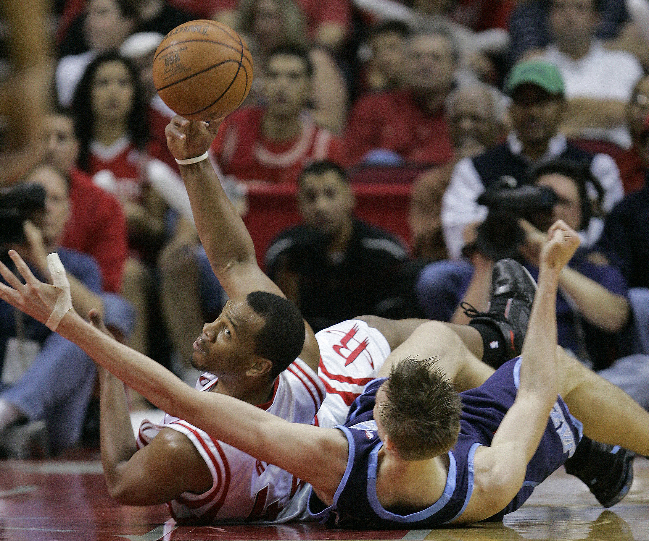Houston Rockets' Chuck Hayes passes the ball as he and Utah Jazz's Andrei Kirilenko, right, of Russia, fall to the floor during the first quarter of their NBA basketball playoff game Saturday, April 21, 2007 in Houston. (AP Photo/David J. Phillip)