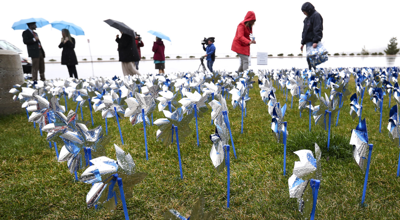 People help place 1,720 pinwheels in the grass at Primary Children’s Hospital in Salt Lake City on Monday, April 15, 2019, as part of the “Pinwheels for Prevention” project. Each pinwheel represents a child who died nationwide as a result of child abuse in 2017. (Photo: Steve Griffin, KSL)