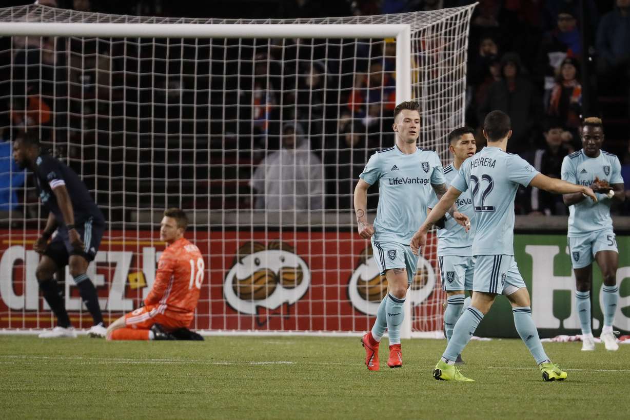 Real Salt Lake midfielder Albert Rusnak, center, celebrates with his teammates after scoring during the first half of an MLS soccer match against FC Cincinnati, Friday, April 19, 2019, in Cincinnati. (AP Photo/John Minchillo)