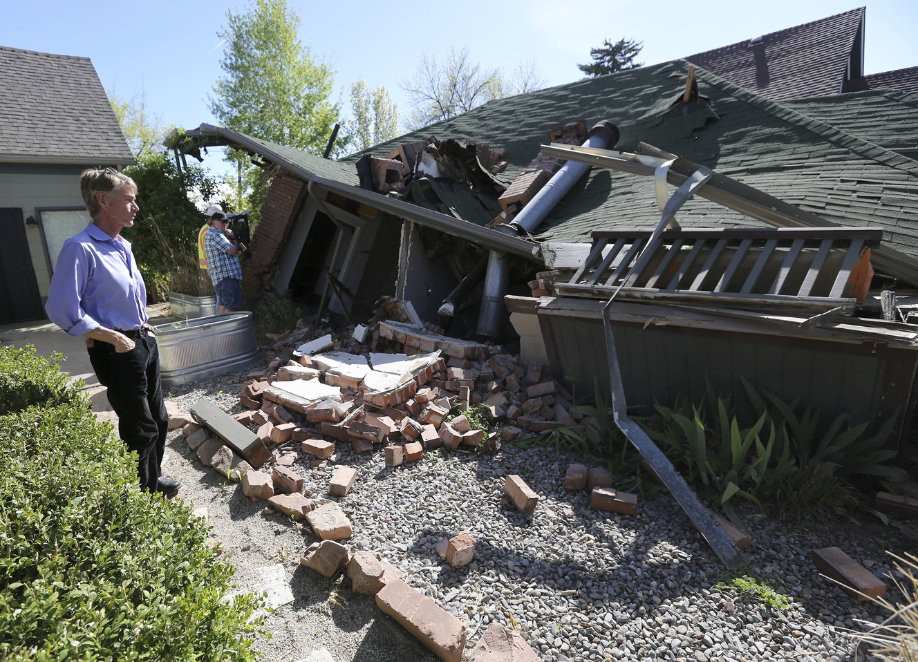 Andy McNeil looks at what is left of the house he lived in from 1984-2002 on Roosevelt Avenue in Salt Lake City on Thursday, April 25, 2019. The house, which was remodeled, collapsed Wednesday evening. (Photo: Kristin Murphy, KSL)