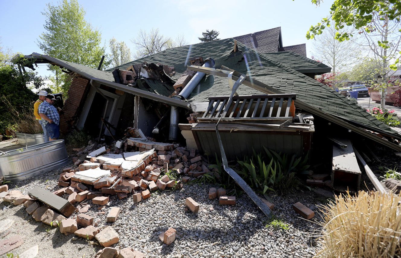 Two men look at a house that collapsed on Roosevelt Avenue in Salt Lake City on Thursday, April 25, 2019. (Photo: Kristin Murphy, KSL)