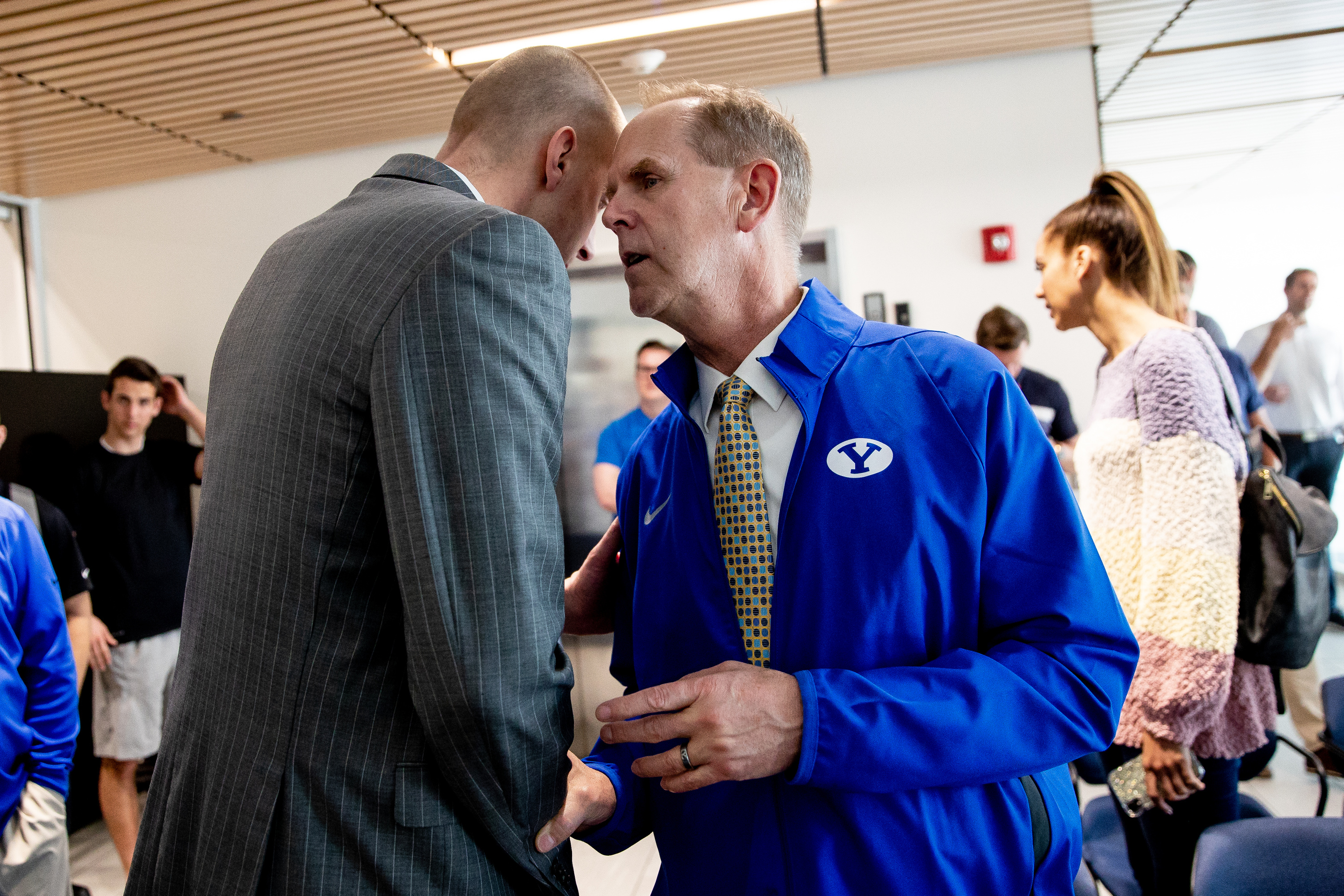 Brigham Young University basketball head coach Mark Pope talks to athletic director Tom Holmoe after a press conference at the Marriott Center Annex in Provo on Thursday, April 25, 2019.