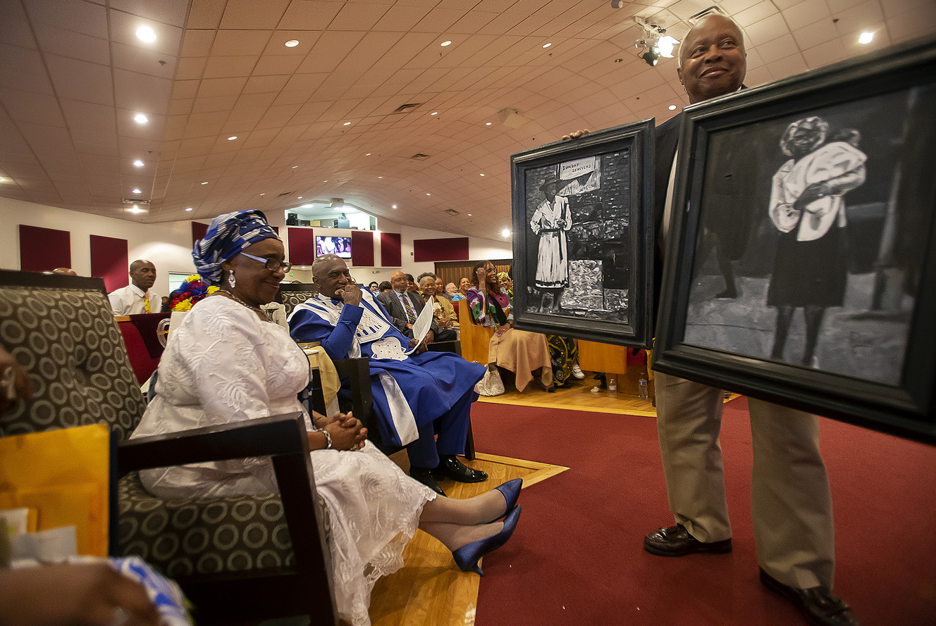 Willene Davis and her husband, the Rev. France Davis, look at a pair of paintings that were given to them at Calvary Baptist Church in Salt Lake City on Sunday, April 28, 2019. After 45 years, the Rev. Davis will retire as pastor of Calvary Baptist Church at the end of the year. (Photo: Scott G Winterton, KSL)