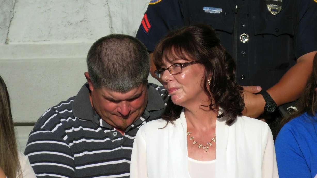 The Latest: Officer helped motorist before he was killed