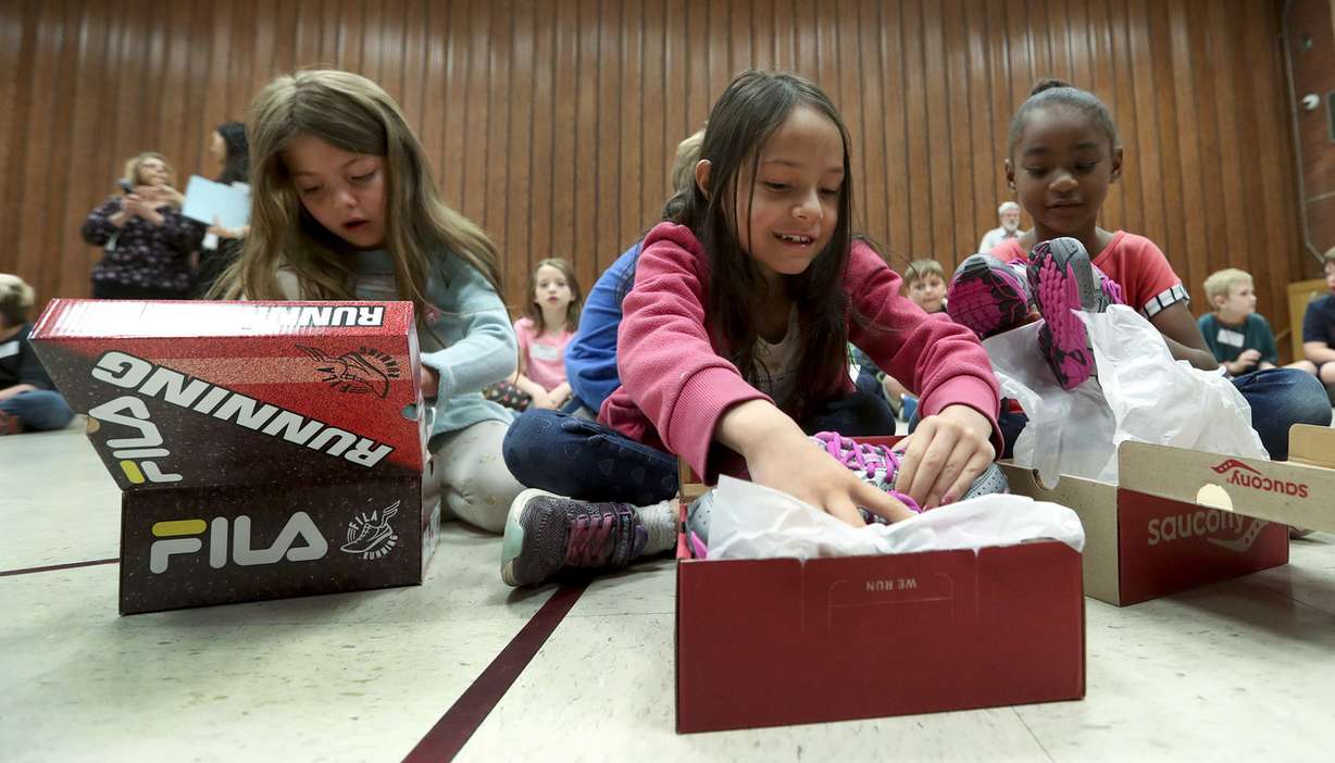 Camila Mendez, Callie Walker and Ekayla Ross, first-graders at M. Lynn Bennion Elementary School, try on their new athletic shoes in the gym during the “Bridge Boots-on-the-Ground” program in Salt Lake City on Thursday, May 9, 2019. Bridge Investment Group and Shoes That Fit have partnered and are sponsoring six elementary schools nationwide. The program will give over 1,200 children new shoes. Along with other partners, Shoes That Fit delivered new athletic shoes to approximately 131,000 children in more than 2,500 schools across 48 states last year. (Photo: Steve Griffin, KSL)