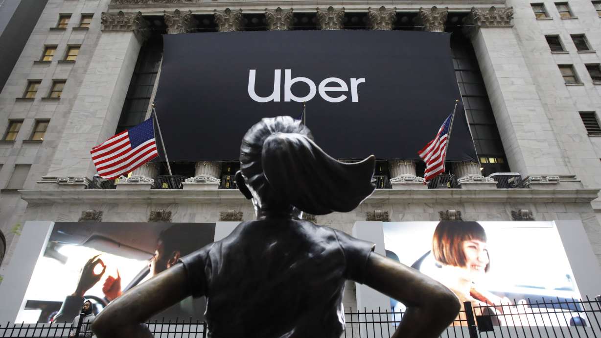 The Latest: Uber stock slides almost 8% on rocky first day