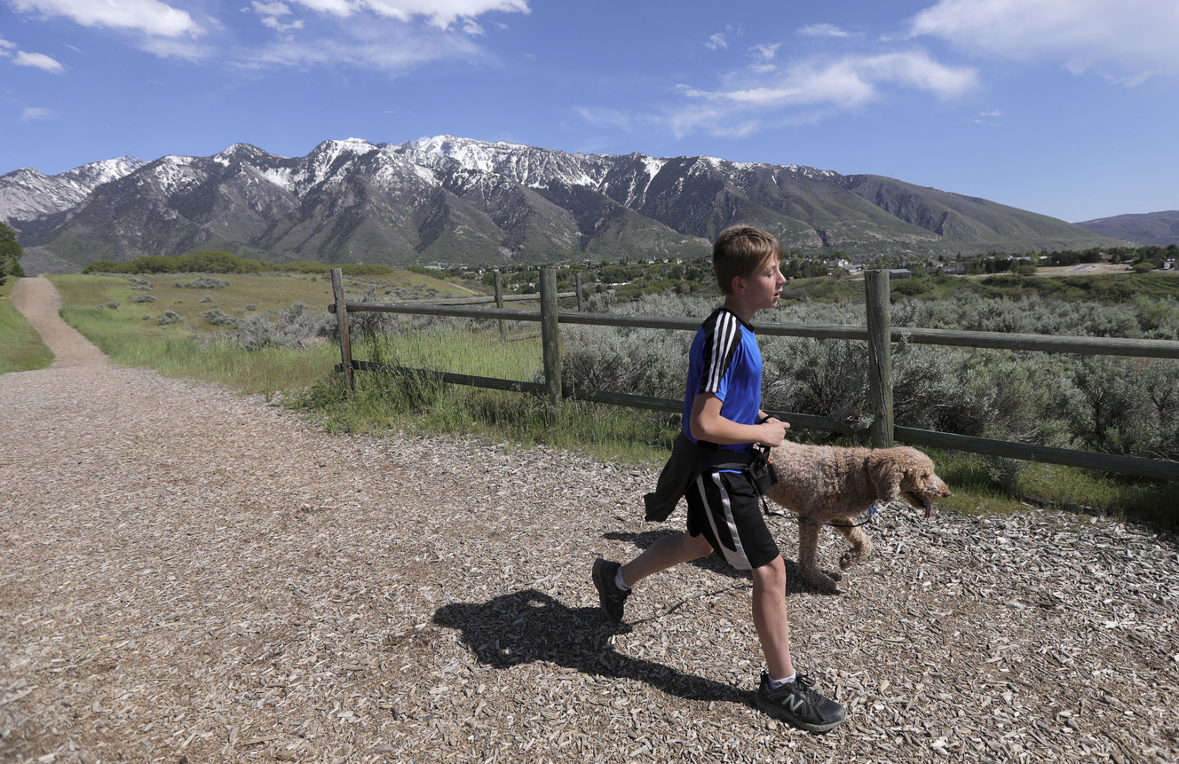 Nathan Drake walks his dog Marley along Dimple Dell Regional Park, the site of a future pedestrian, equestrian and bike bridge connecting to existing and expanding trails, in Sandy on Monday, May 13, 2019. (Photo: Kristin Murphy, KSL)