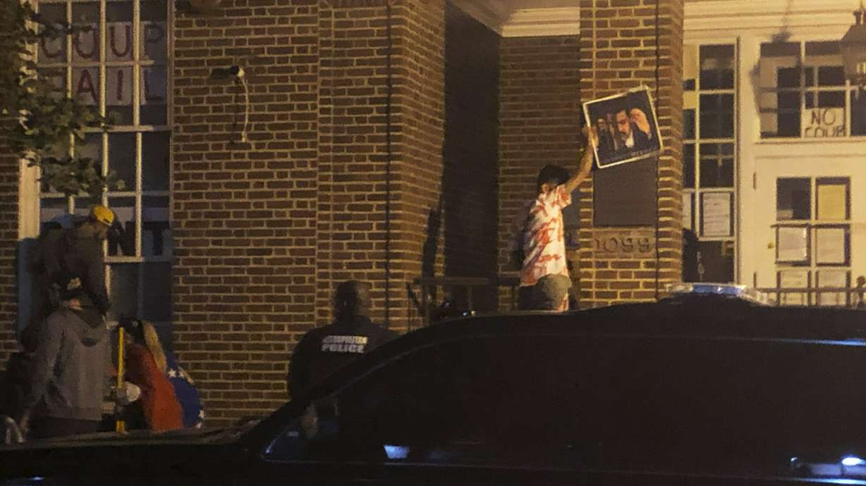 Activists at Venezuelan embassy in US ignore warning