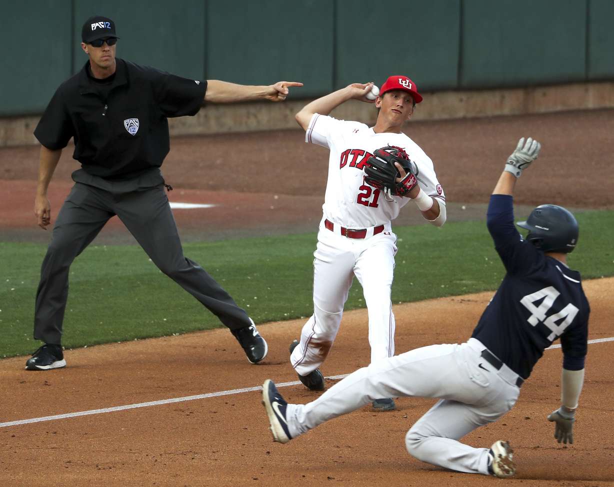 Ute third baseman Chase Fernlund fires to first for an out as Cougar baserunner Brock Hale slides safely into third during the Utah vs. BYU baseball game at Smith’s Ballpark in Salt Lake City on Tuesday, May 14, 2019. (Photo: Steve Griffin, KSL)