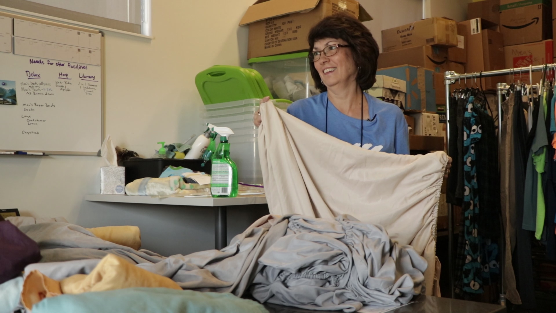 Kathy Wagner laughs while folding sheets and talking to another volunteer at the Volunteers of America Youth Resource Center in Salt Lake City. Kathy spends four days a week volunteering at the center. (Photo: Yvette Cruz, KSL.com)