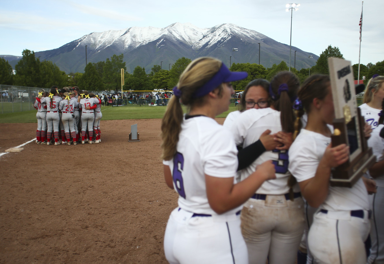 While the Tooele Buffaloes celebrate the defeated Spanish Fork Dons huddle by third base after losing 3-1 to the Tooele Buffaloes during the state championship at the Spanish Fork Sports Park in Spanish Fork on Saturday, May 18, 2019. (Photo: Silas Walker, KSL)