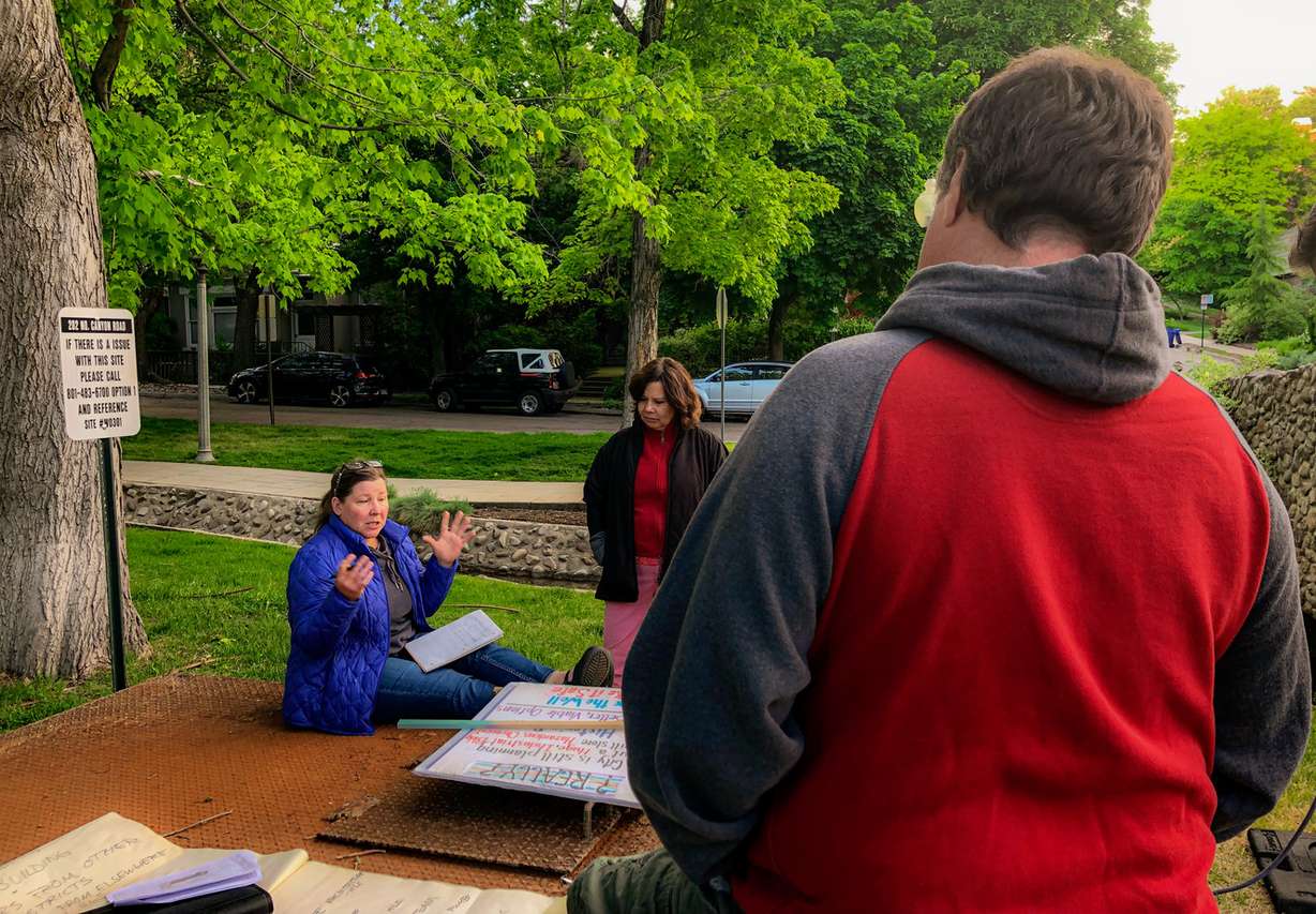 Salt Lake City resident Lisa Livingston, left, and Victoria Waler, center, chat with a person walking by the 4th Avenue well about the proposed project to build an above-ground pump on Monday, May 20, 2019. Many residents near the well oppose the project. (Photo: Carter Williams, KSL.com)