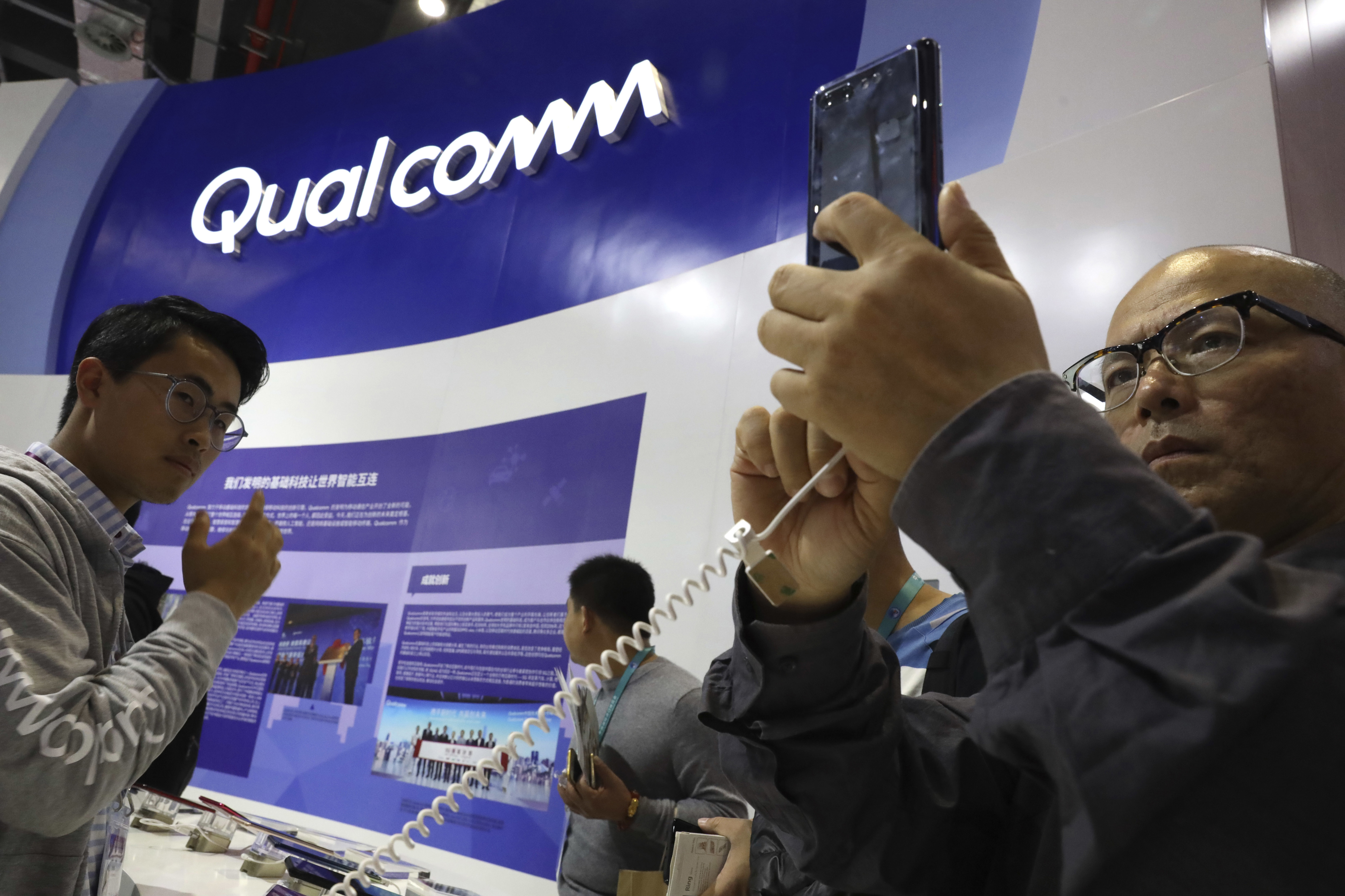 The Latest: Qualcomm defeat might not lower phone prices