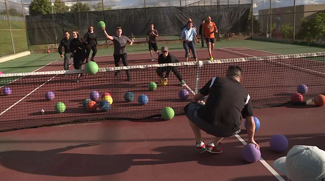 Dodgeball players rush to the net to grab a ball and try not to get hit by the opposing team. (Photo: KSL TV)