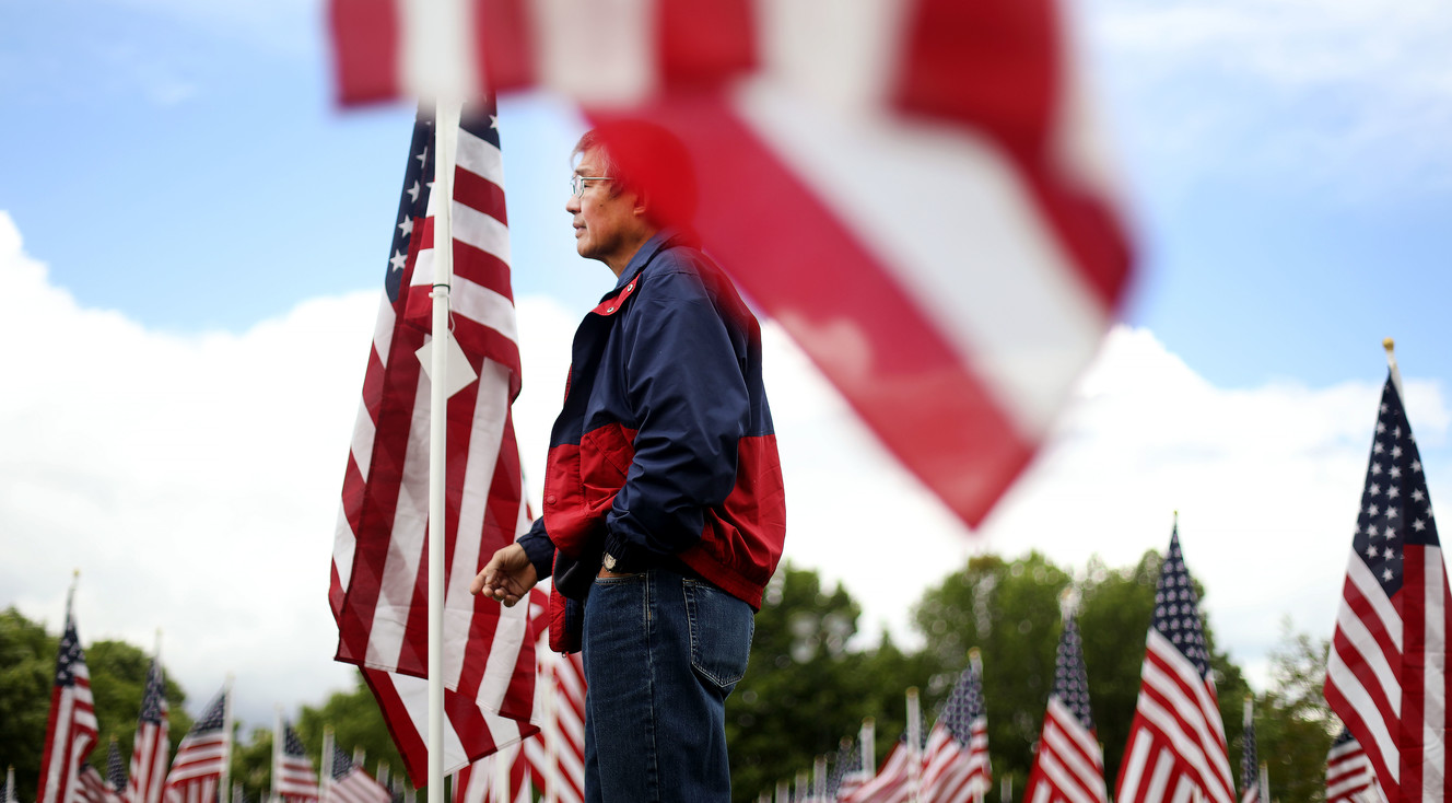 Ronald Higashiyama, of Sandy, walks through the Utah 9/11 Healing Field at the 9/11 Never Forget Mobile Exhibit at Centennial Park in West Valley City on Thursday, May 23, 2019. Higashiyama is a retired command sergeant major in the military and a civilian with the Department of the Army. (Photo: Laura Seitz, KSL)