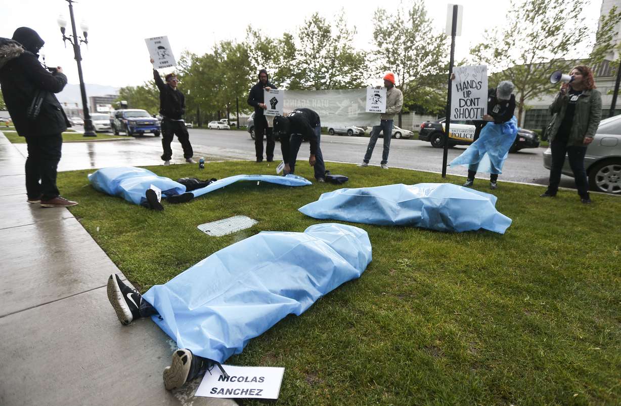 Protesters demonstrate outside the Salt Lake County District Attorney’s Office in Salt Lake City on Friday, May 24, 2019. The protesters laid on the grass in bags with nametags of individuals killed by police. (Photo: Silas Walker, KSL)