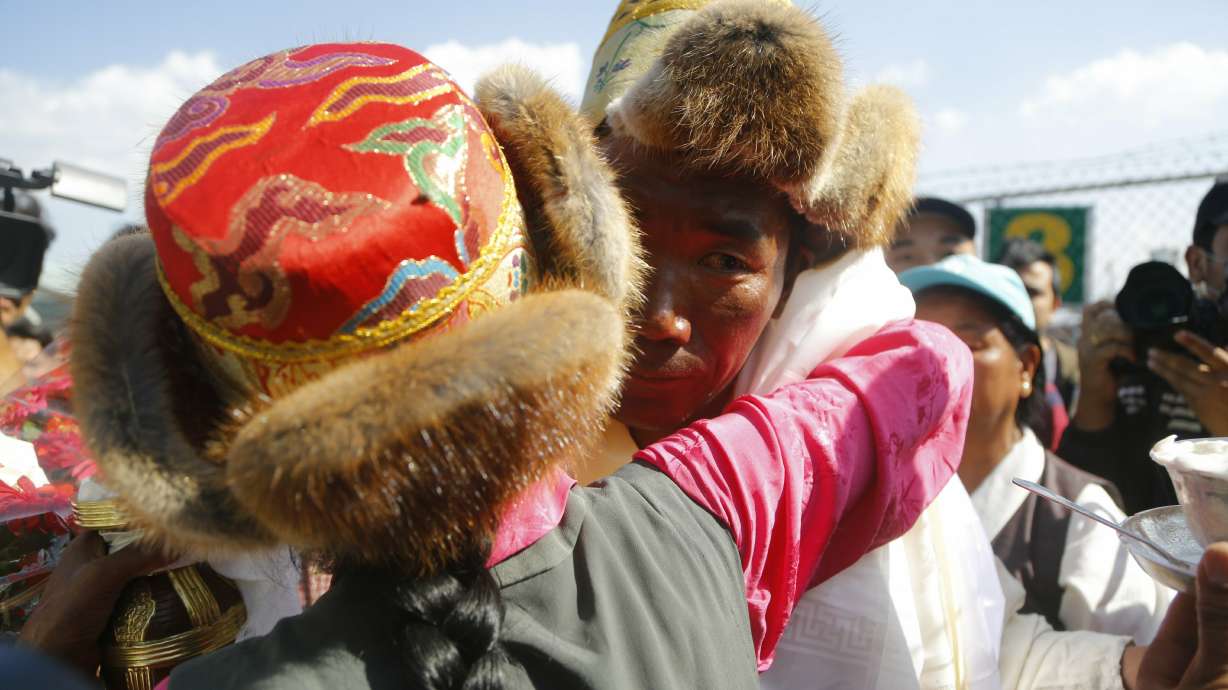 Nepal's record-setting Everest guide returns hero