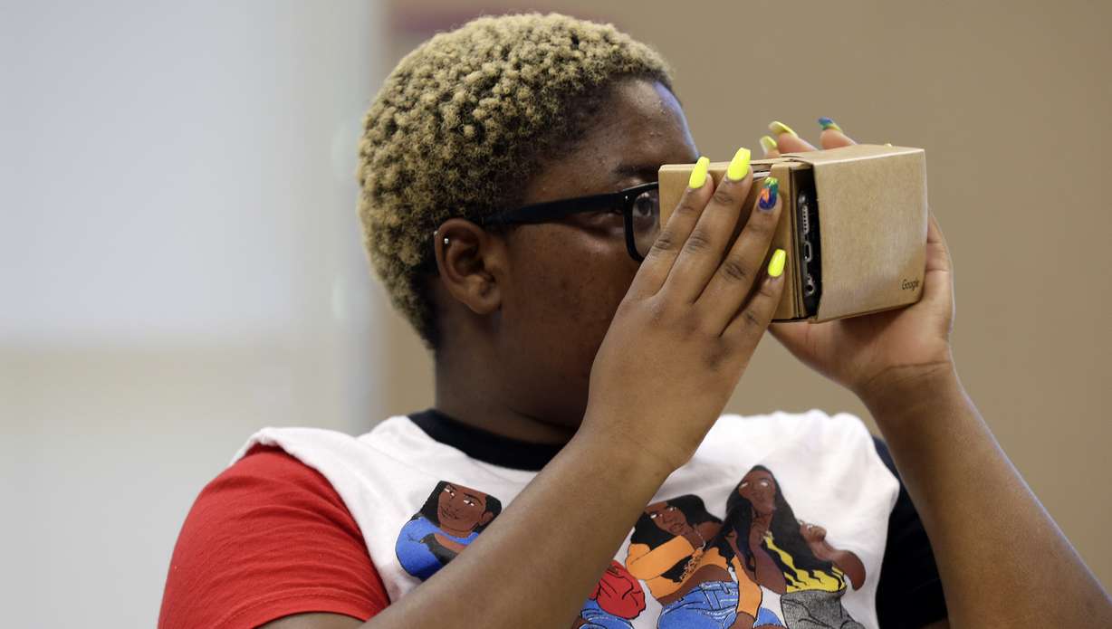 In this photo taken Tuesday, May 21, 2019, Nydasia Lewis uses a virtual reality visual aid along with fellow 11th grade students learning about the D-Day invasion at Normandy during a history class at Crossroads FLEX school in Cary, N.C. (Photo: Gerry Broome, AP)