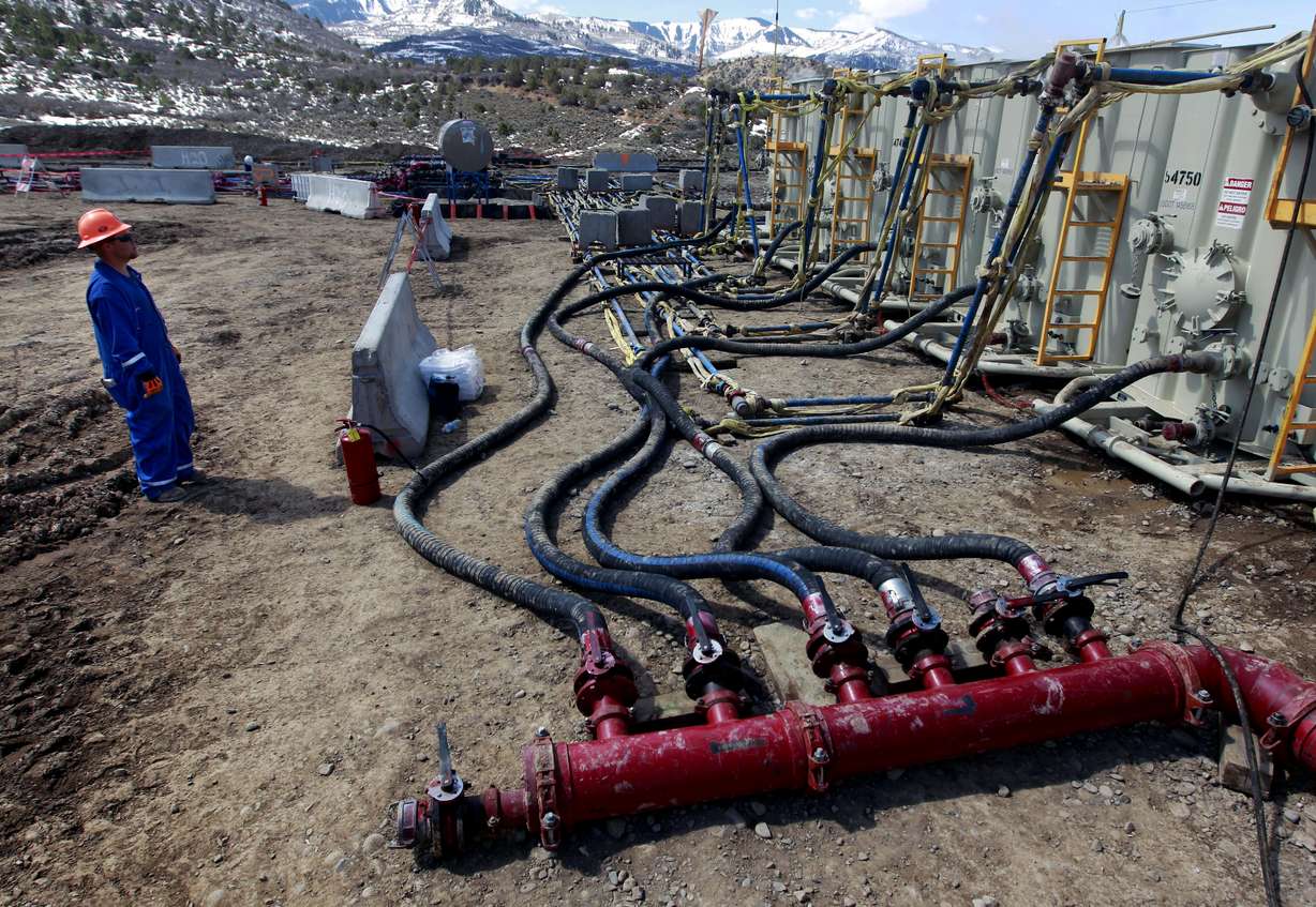 FILE - In this March 29, 2013, file photo, a worker helps monitor water pumping pressure and temperature, at an oil and natural gas extraction site, outside Rifle, on the Western Slope of Colorado. Photo: Brennan Linsley, AP Photo, File