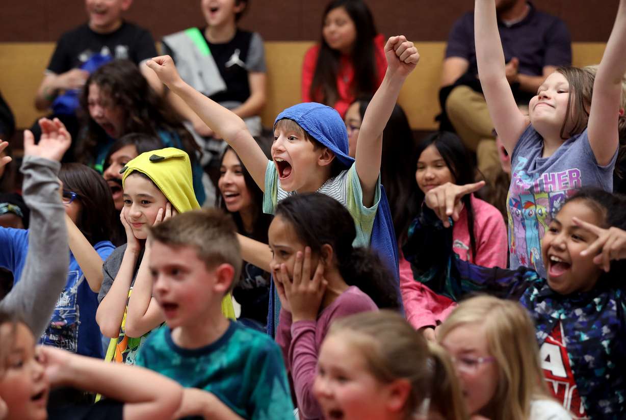 Students at Washington Elementary School in Salt Lake City cheer after learning their school is receiving 23 instruments on Thursday, May 30, 2019. The school received trumpets, trombones, flutes and clarinets to start a music program when school starts in the fall. (Photo: Laura Seitz, KSL)