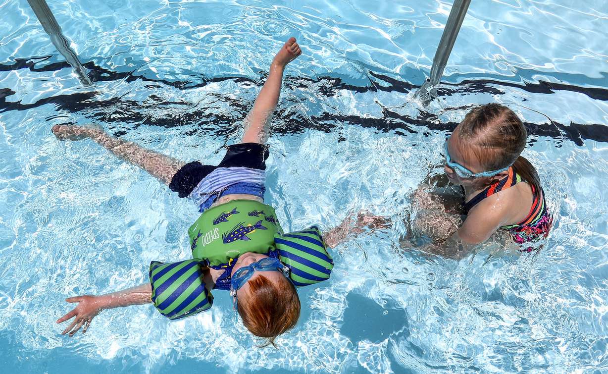 Nathan Miles, 3, shows his cousin, Sydney Birkland, how he can float on his back as they swim at the I.J. & Jeanné Wagner Jewish Community Center swimming pool in Salt Lake City on Friday, May 31, 2019. (Photo: Steve Griffin, KSL)